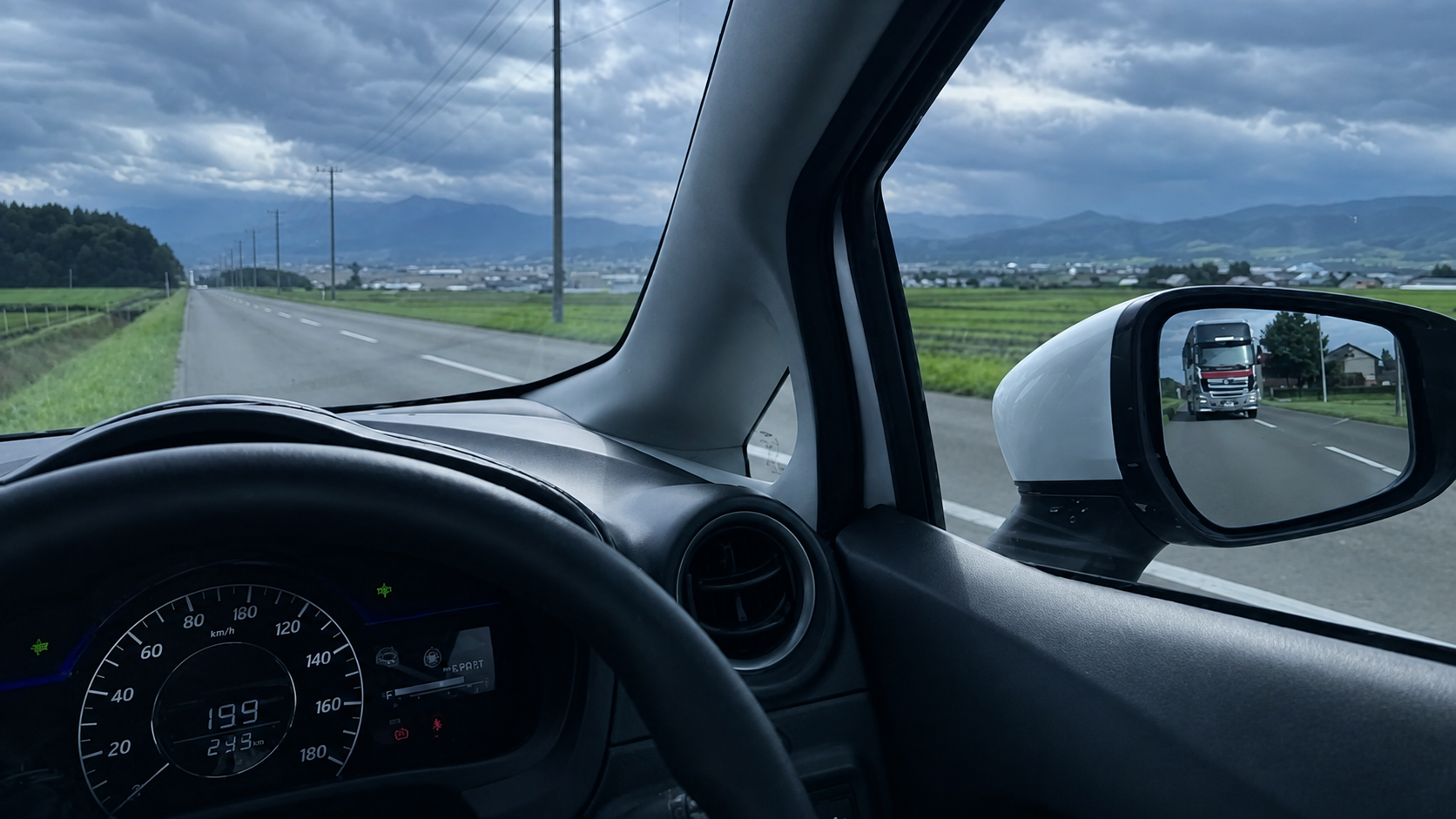 HOK-101-03 · a road disappearing between two destinations — 16:9