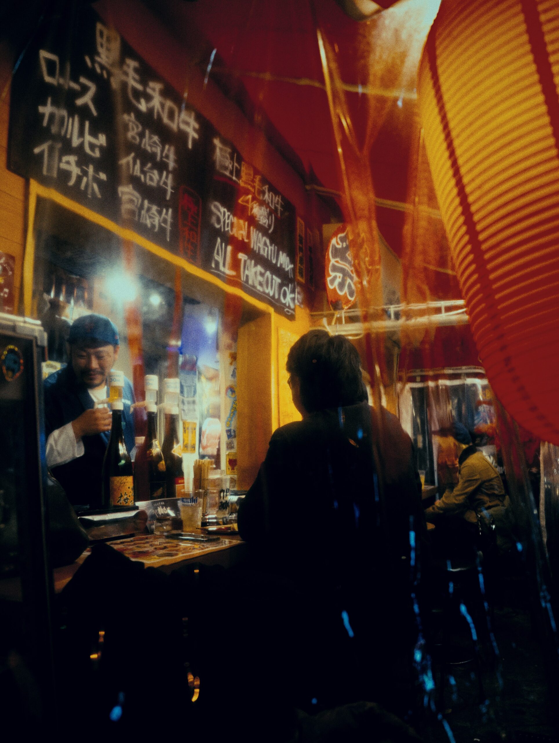 KAN-OSAKA-02 · a shopkeeper mid-service, handwritten menu behind — 3:4, 1000×1333