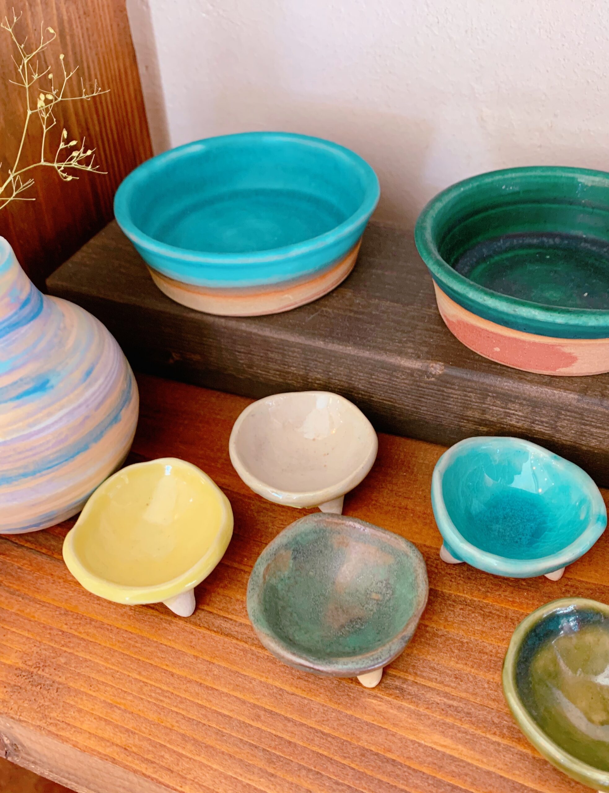 OKI-LIST-02 · a small Tsuboya shop interior, shelves of pottery, natural light. 3:4, 1100×1466