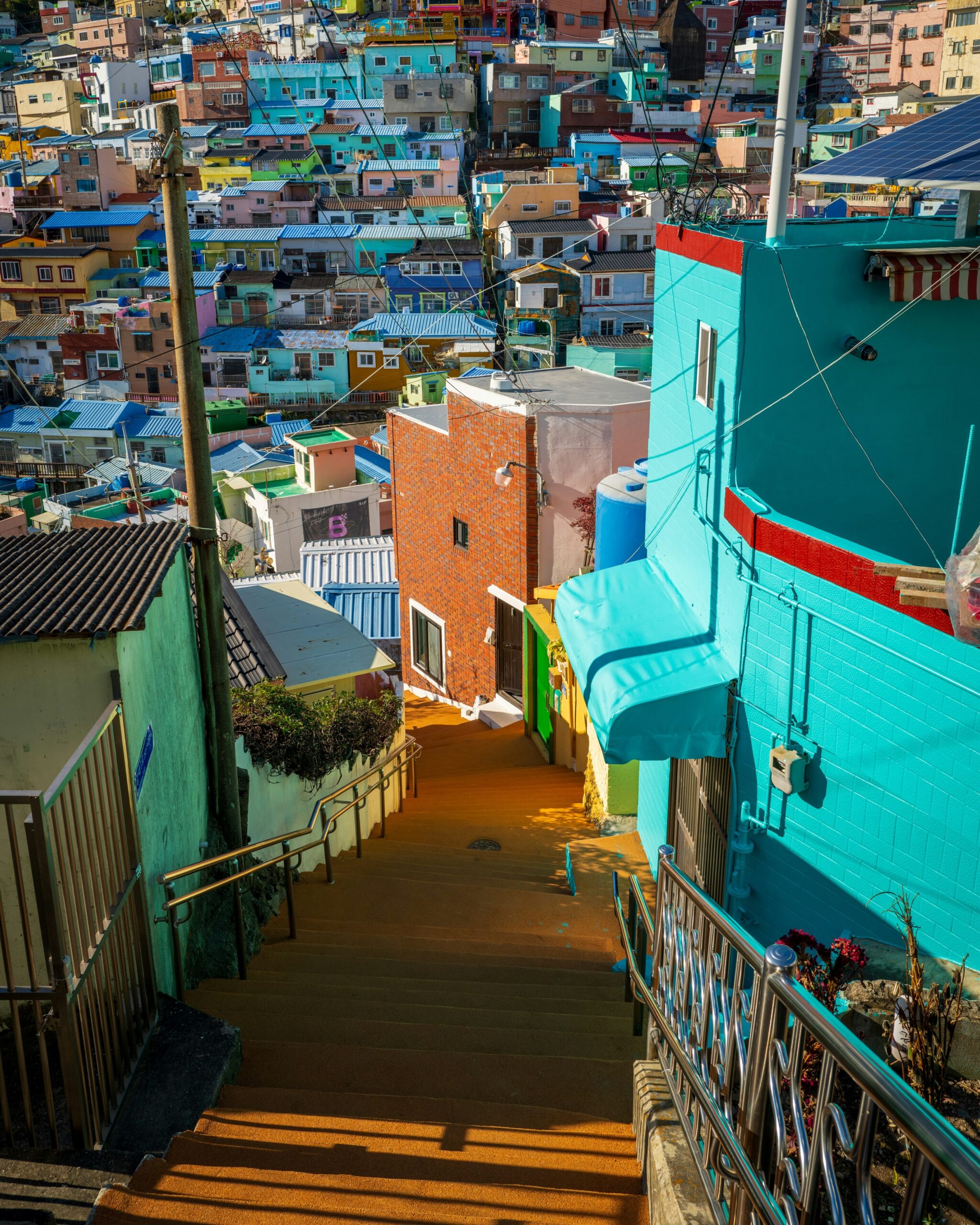 BS-HILL-02 · stairs between houses, handrails, potted plants, laundry. 4:5, 1200×1500