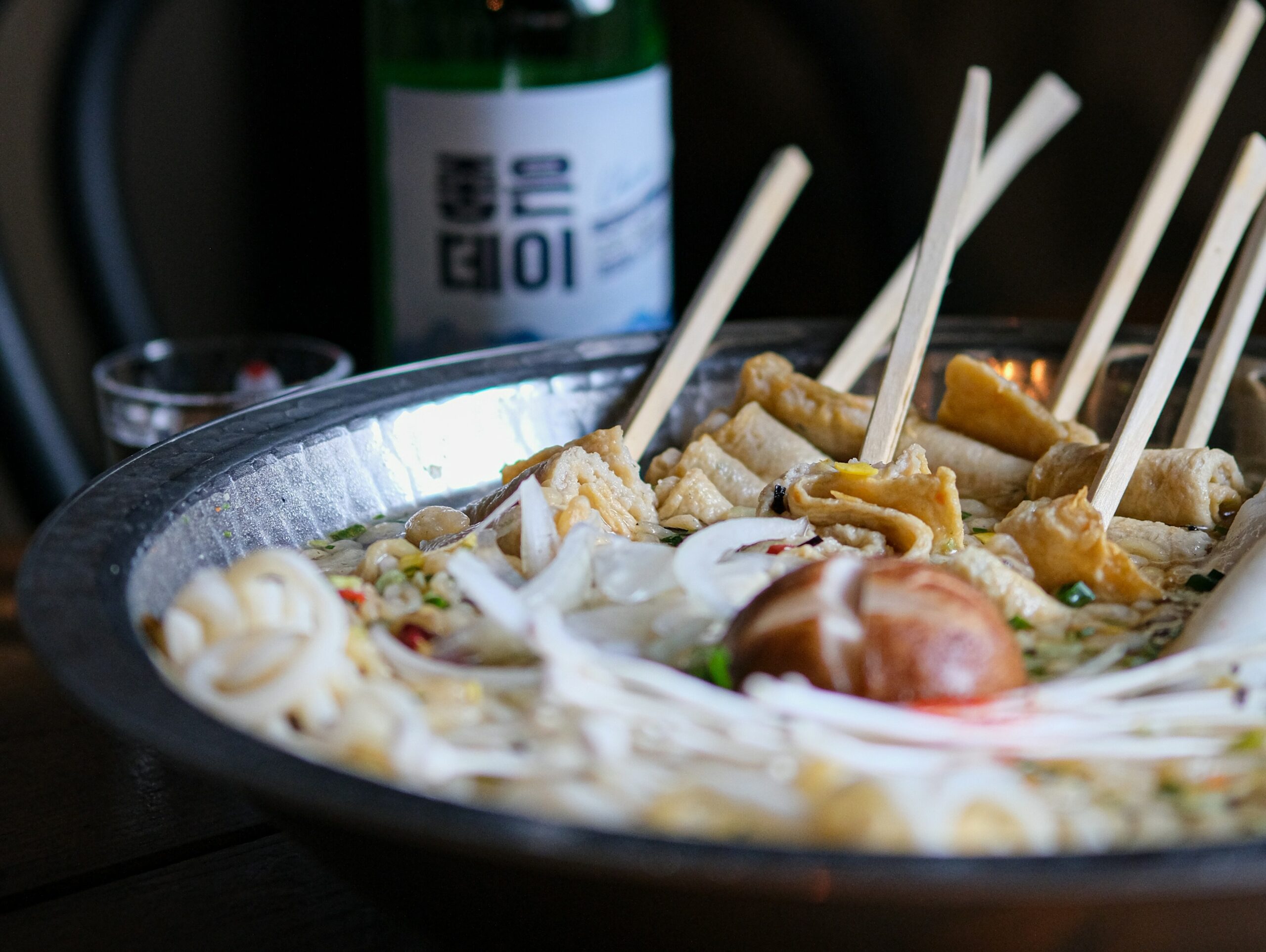 BS-EAT-02 · eomuk / fish cake stall, hands and paper cups, imperfect and human. 4:3, 1600×1200