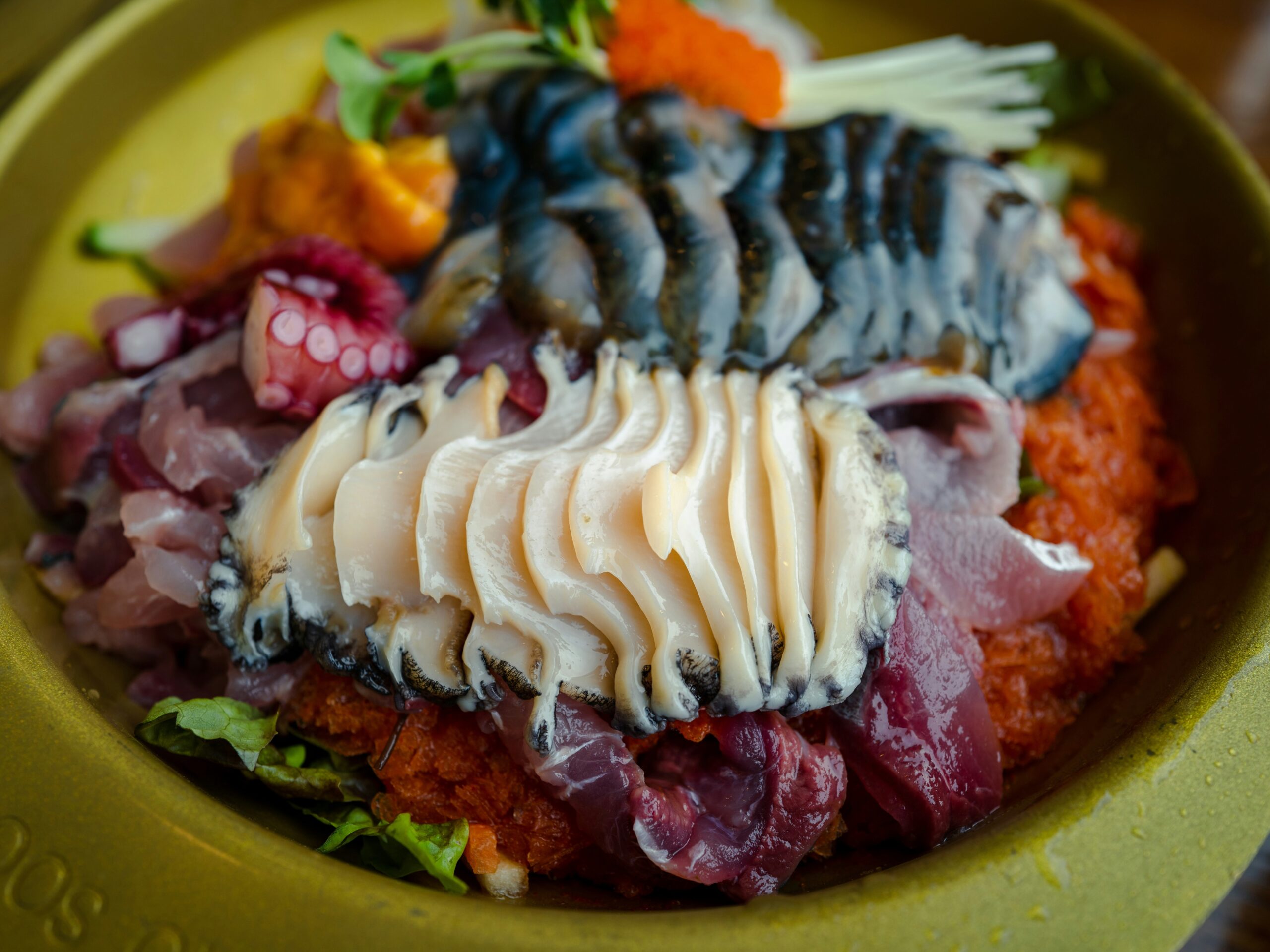 BS-EAT-04 · seafood shared at a harbour-side table, plates and hands mid-meal. 4:3, 1600×1200