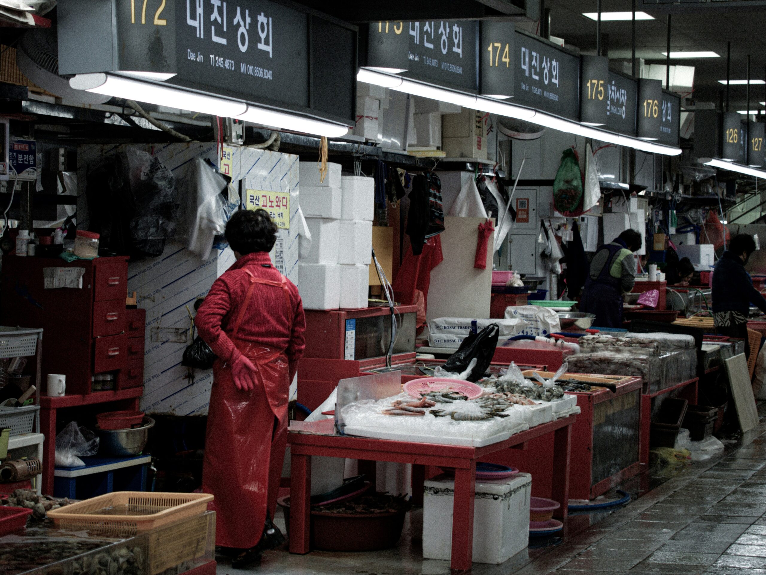 BS-DAY-02 · first light at the market, shutters going up. 4:3, 1200×900