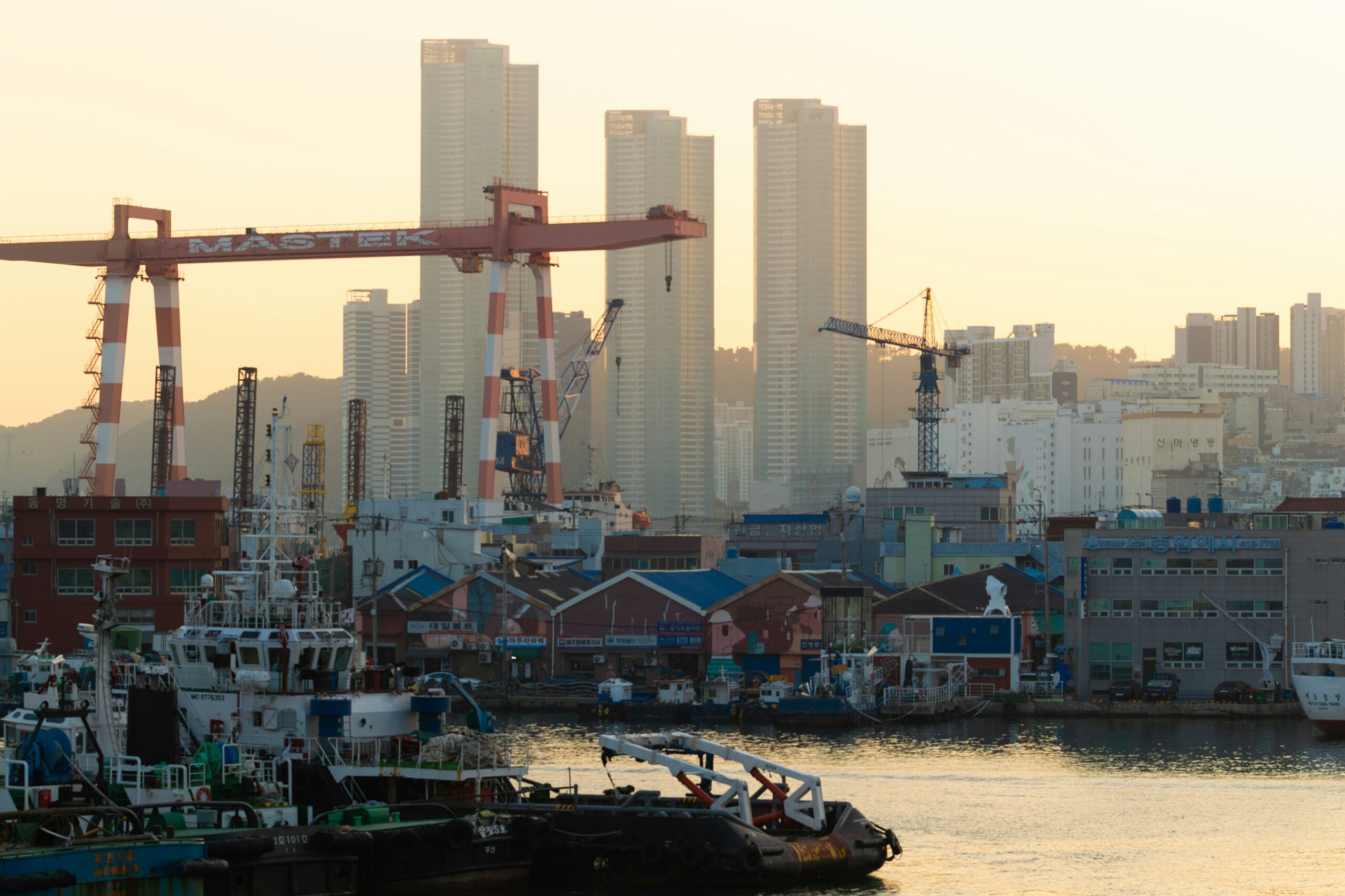 BS-PLAN-01 · harbour and market rooftops in morning light. 3:2, 1200×800