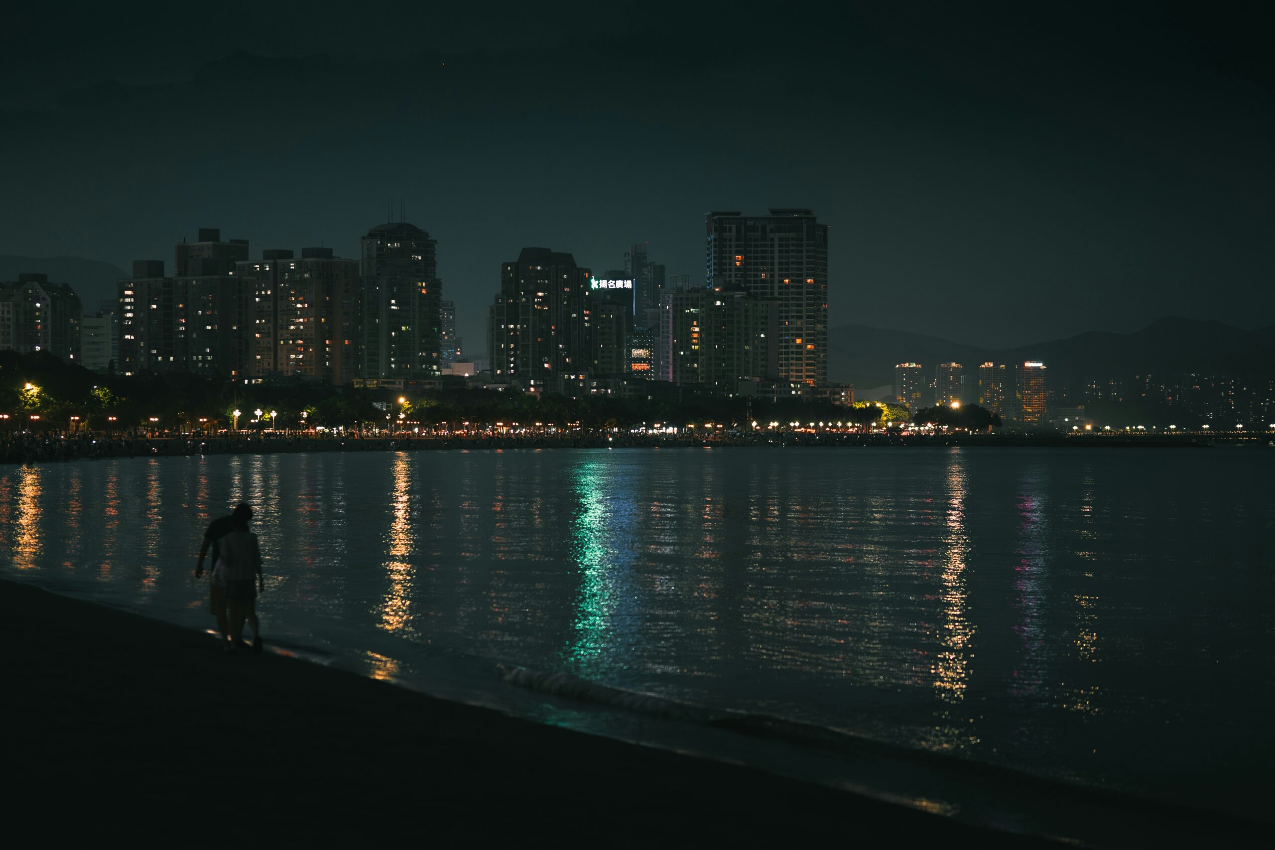 BS-DAY-05 · late evening by the water, someone sitting on the seawall. 3:2, 1800×1200